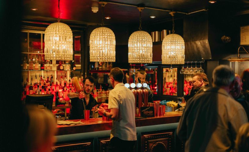 People stood at bar at The Bootlegger in Bath